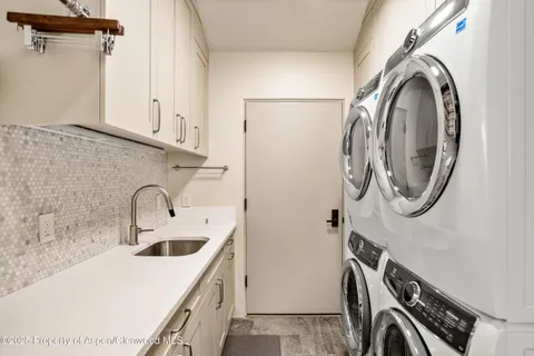 a utility room with a sink a washer and dryer