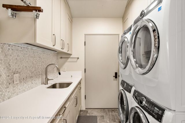 a utility room with a sink a washer and dryer