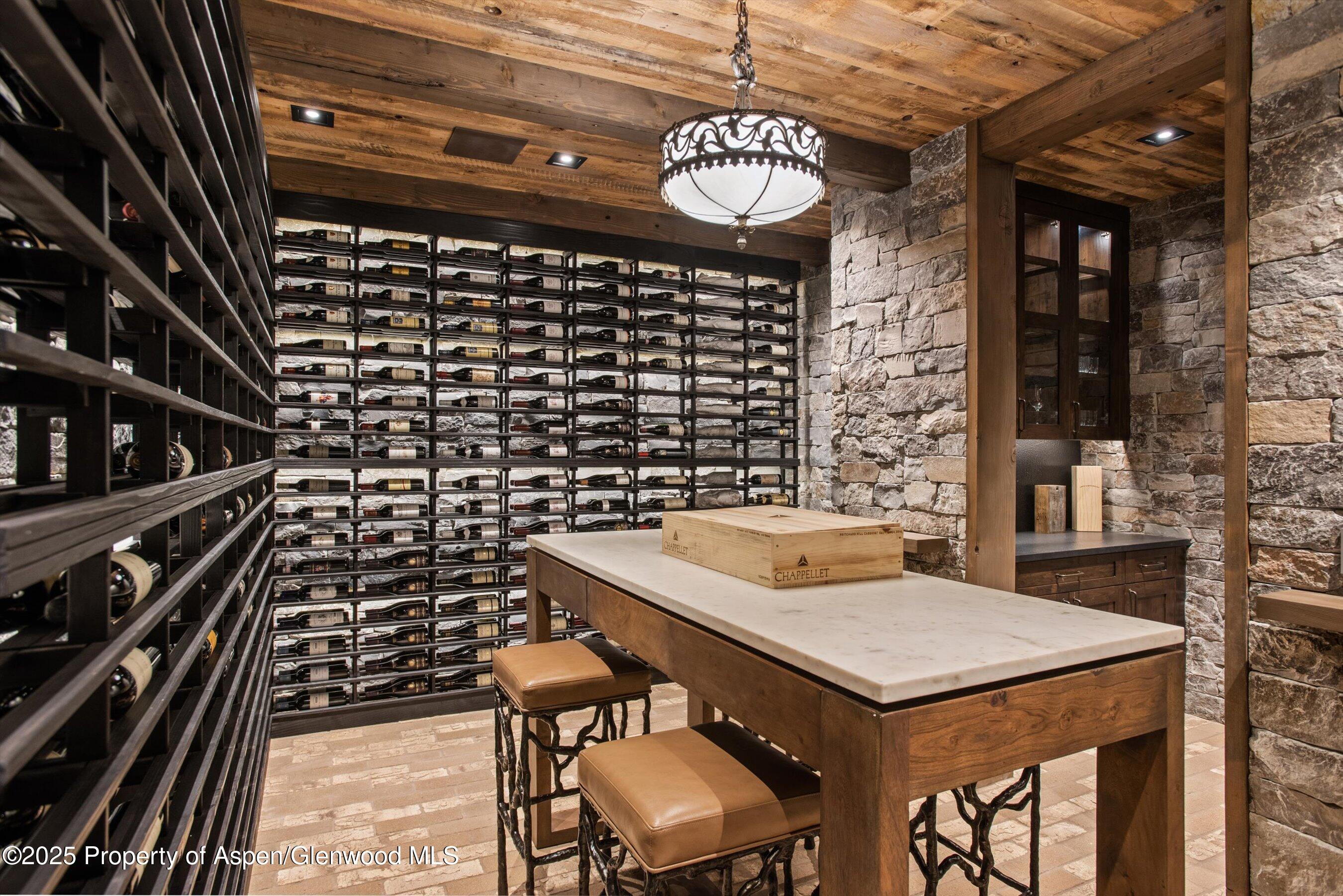 2318 Lazy O Road Snowmass, CO 81654 - Photo 34 of 50 a kitchen with a sink a stove and chairs