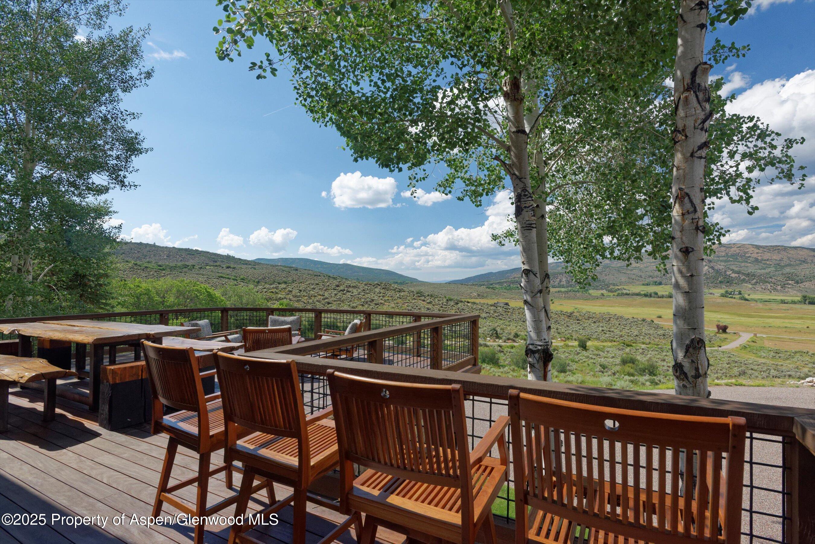 2318 Lazy O Road Snowmass, CO 81654 - Photo 39 of 50 a view of a wooden chairs and table in the balcony