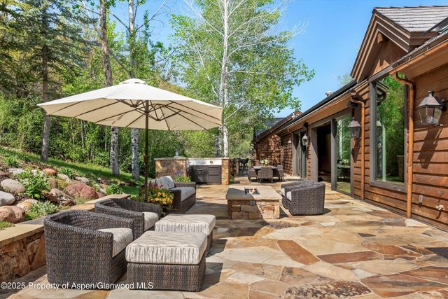 a view of a patio with couches chairs potted plants and a table and chairs