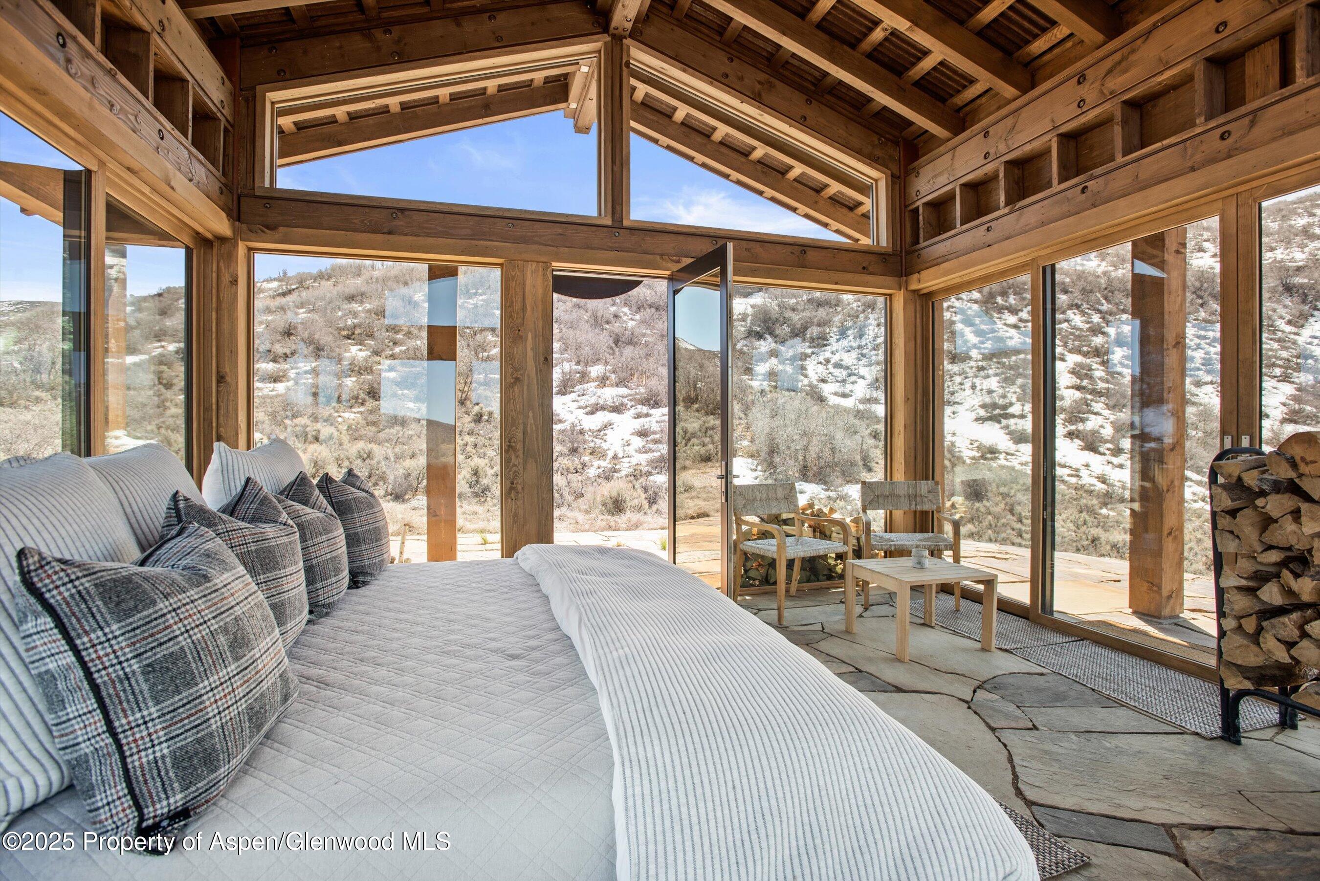 2318 Lazy O Road Snowmass, CO 81654 - Photo 45 of 50 a large bedroom with furniture and large windows