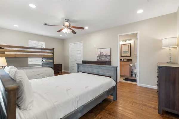 a bedroom with bed and wooden floor