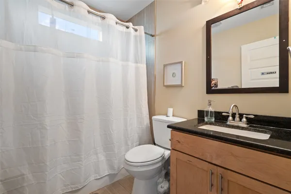a bathroom with a sink a toilet and a mirror