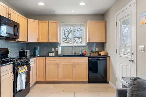 a kitchen with stainless steel appliances granite countertop a stove sink and cabinets