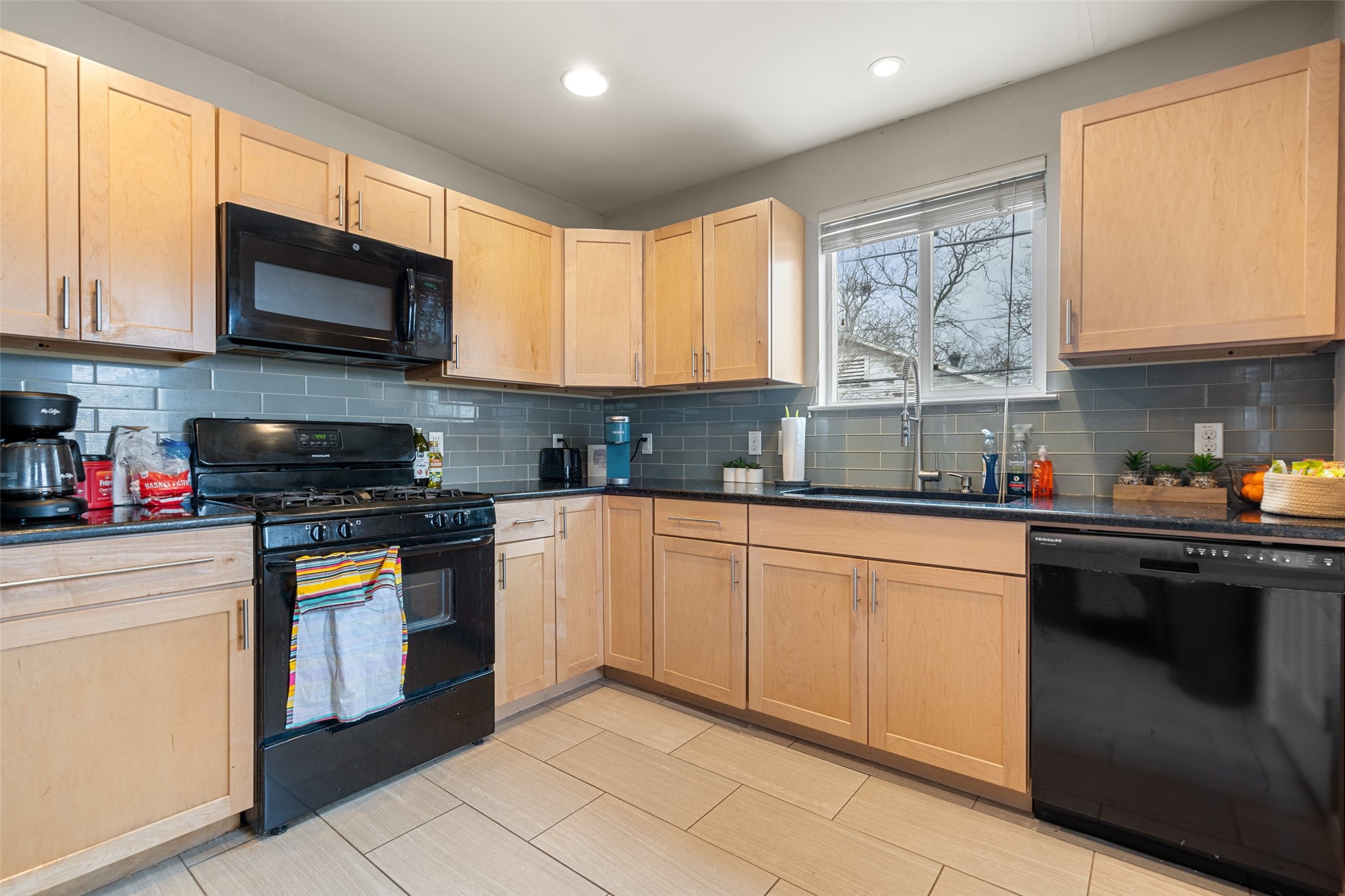 3504 Speedway, Unit A&B Austin, TX 78705 - Photo 23 of 29 a kitchen with stainless steel appliances granite countertop a stove sink microwave and window