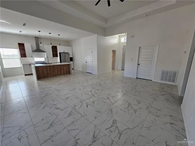 a view of a livingroom with furniture and a ceiling fan