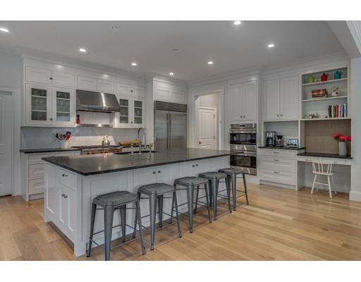 77 Edwardel Road Needham, MA 02492 - Photo 4 of 10 a kitchen with stainless steel appliances granite countertop a sink a stove a refrigerator a dining table and chairs
