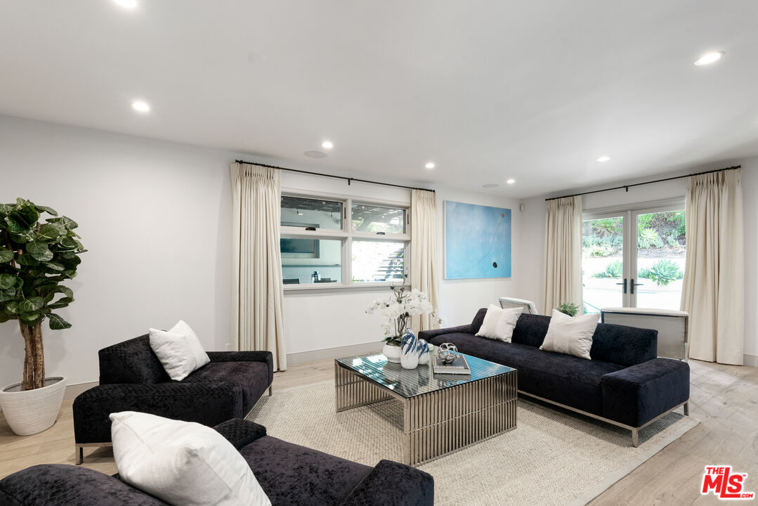 1104 Acanto Place Los Angeles, CA 90049 - Photo 11 of 39 a living room with furniture and a large window