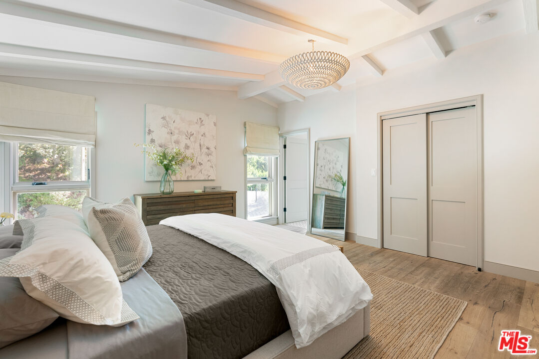 1104 Acanto Place Los Angeles, CA 90049 - Photo 15 of 39 a bedroom with a large bed and a large window