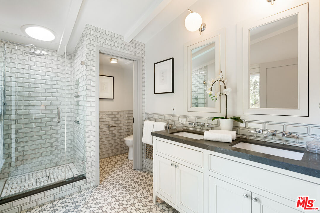 1104 Acanto Place Los Angeles, CA 90049 - Photo 17 of 39 a bathroom with a sink a toilet and shower