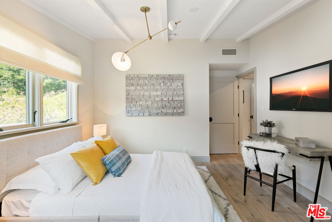1104 Acanto Place Los Angeles, CA 90049 - Photo 19 of 39 a bedroom with a bed window and table