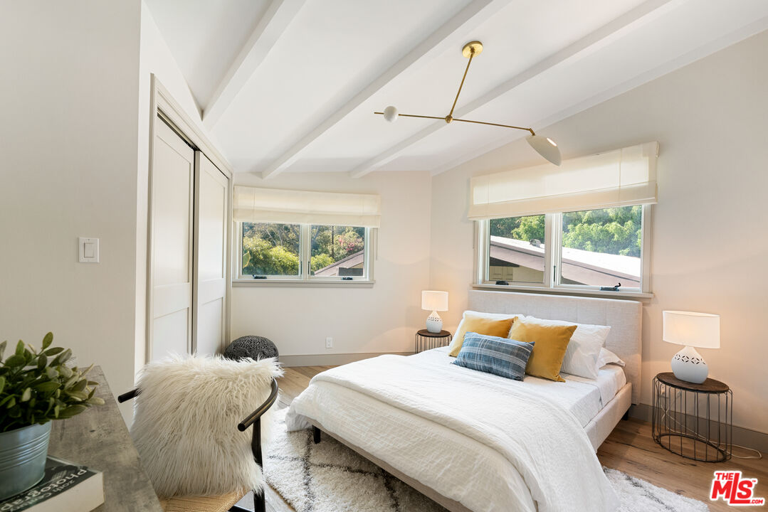 1104 Acanto Place Los Angeles, CA 90049 - Photo 20 of 39 a bedroom with a bed and a window