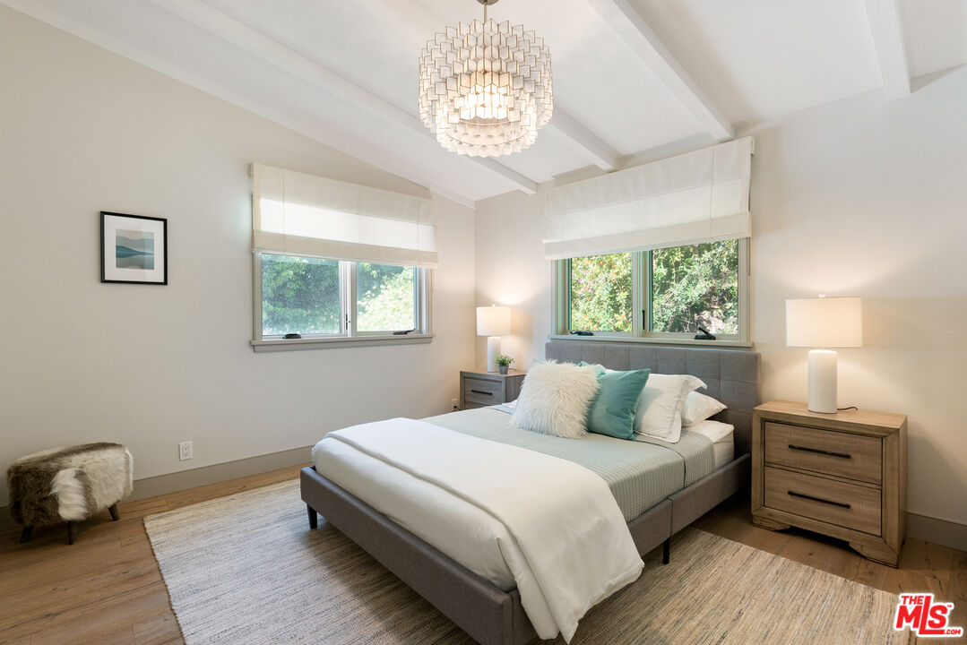 1104 Acanto Place Los Angeles, CA 90049 - Photo 22 of 39 a bedroom with a bed and a window