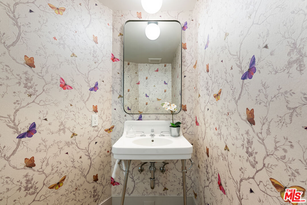 1104 Acanto Place Los Angeles, CA 90049 - Photo 24 of 39 a bathroom with a sink and a mirror