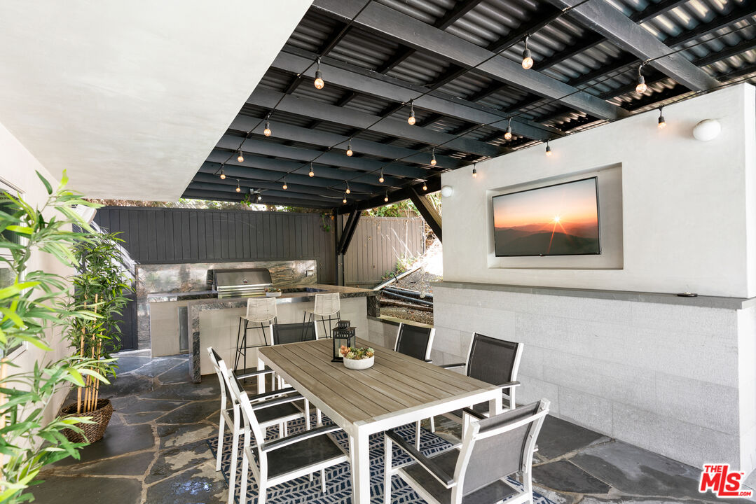 1104 Acanto Place Los Angeles, CA 90049 - Photo 30 of 39 a view of a dinning table and chairs in patio