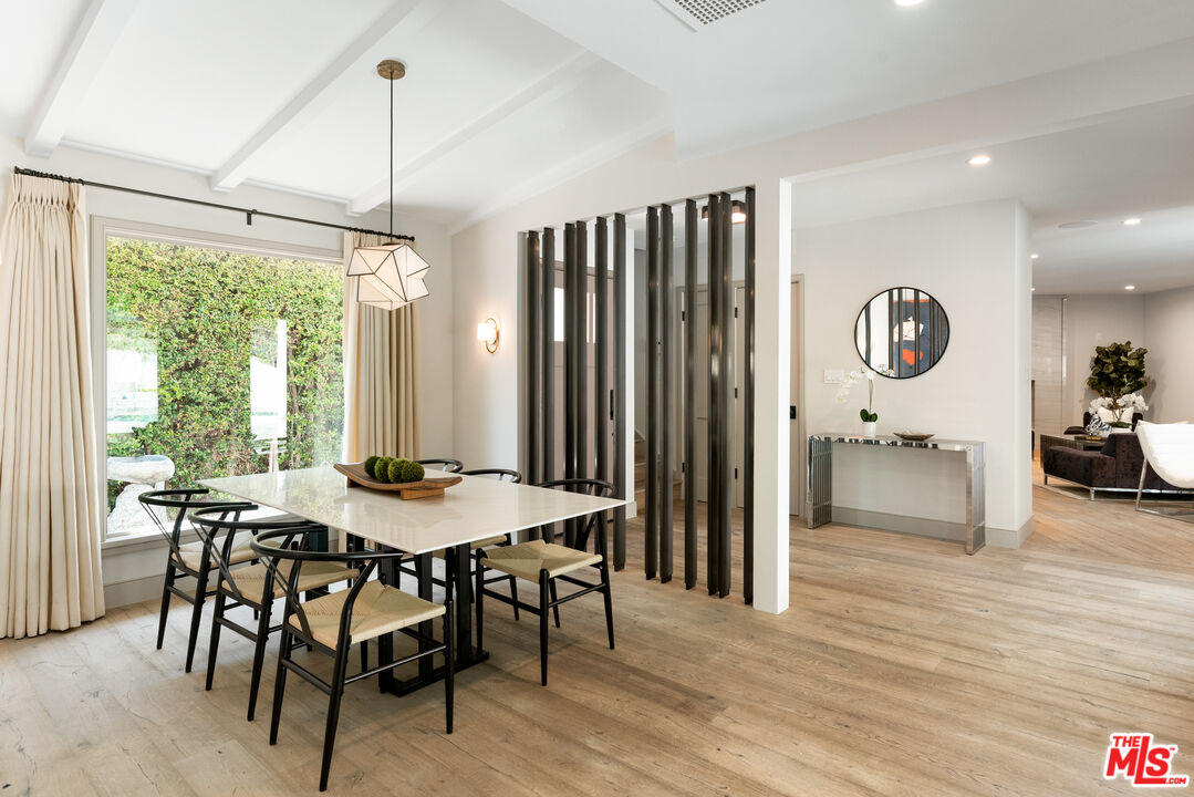 1104 Acanto Place Los Angeles, CA 90049 - Photo 3 of 39 a view of a a dining room with furniture window and wooden floor