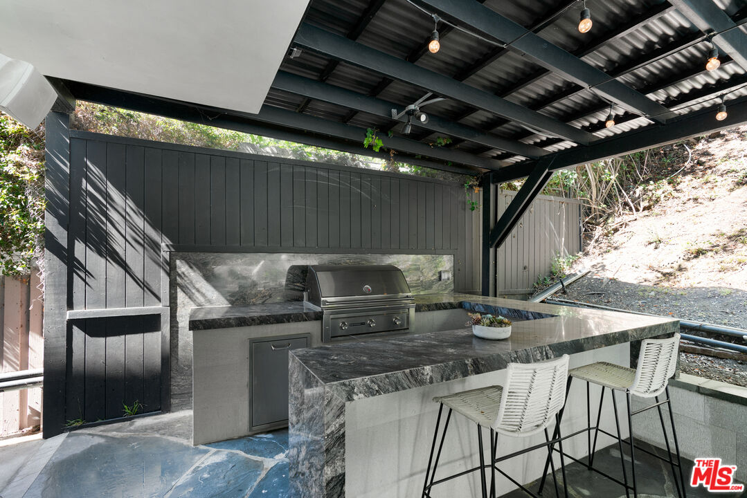 1104 Acanto Place Los Angeles, CA 90049 - Photo 32 of 39 a kitchen with table and chairs