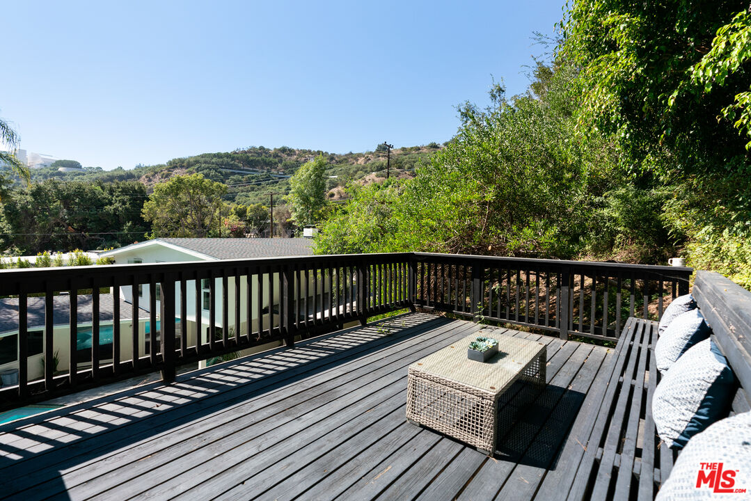 1104 Acanto Place Los Angeles, CA 90049 - Photo 34 of 39 a view of balcony with wooden floor and fence