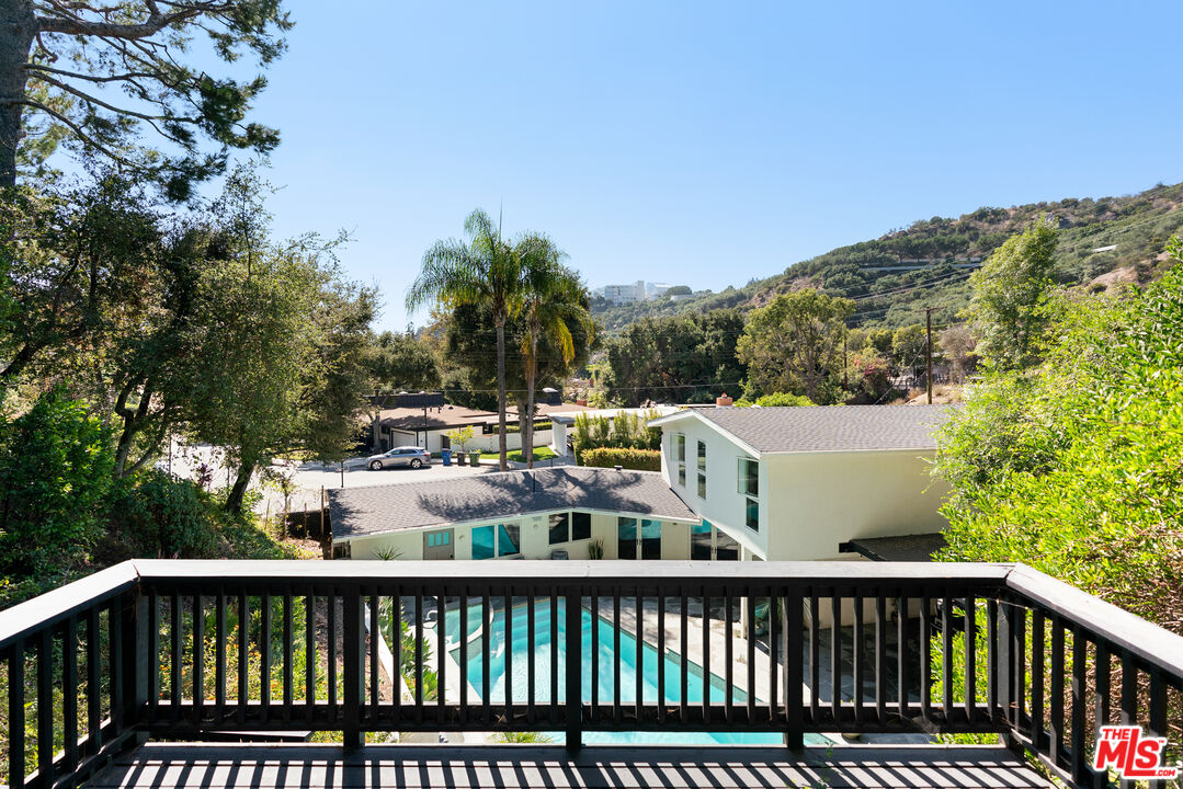 1104 Acanto Place Los Angeles, CA 90049 - Photo 35 of 39 a view of a balcony with two chairs and a table