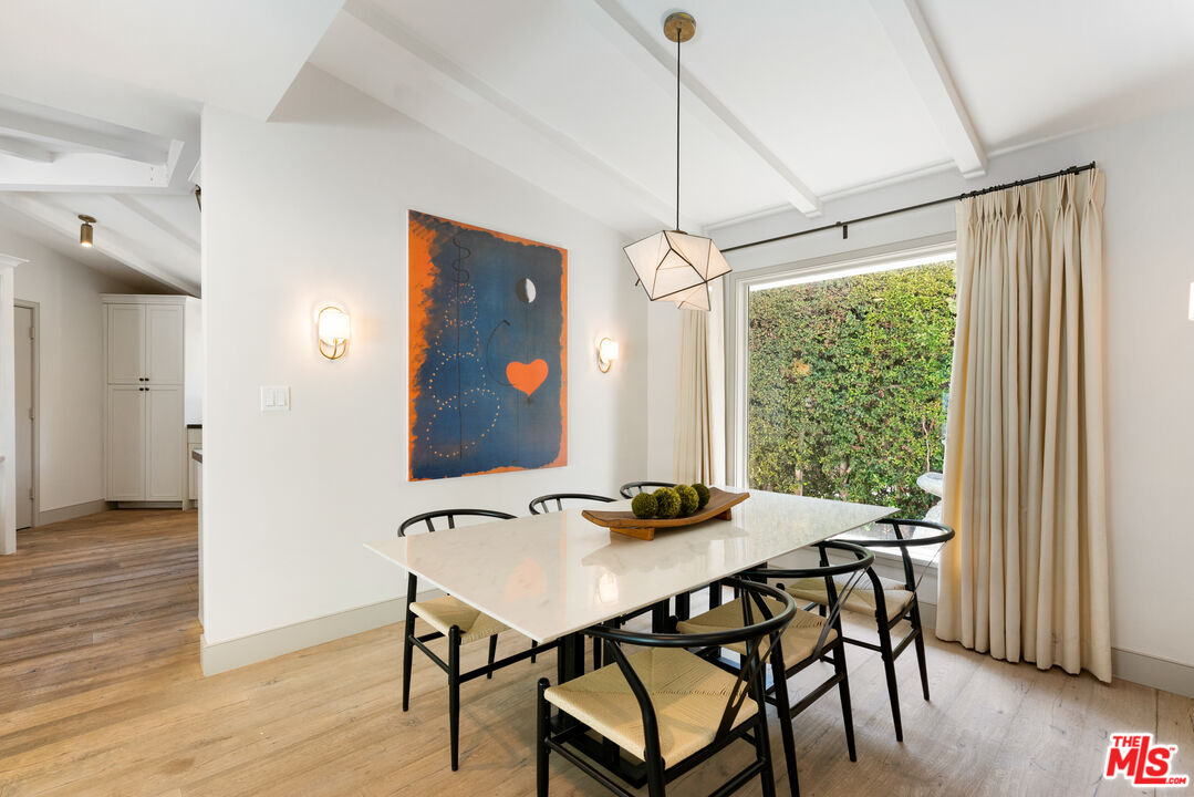 1104 Acanto Place Los Angeles, CA 90049 - Photo 5 of 39 a view of a dining room with furniture window and wooden floor