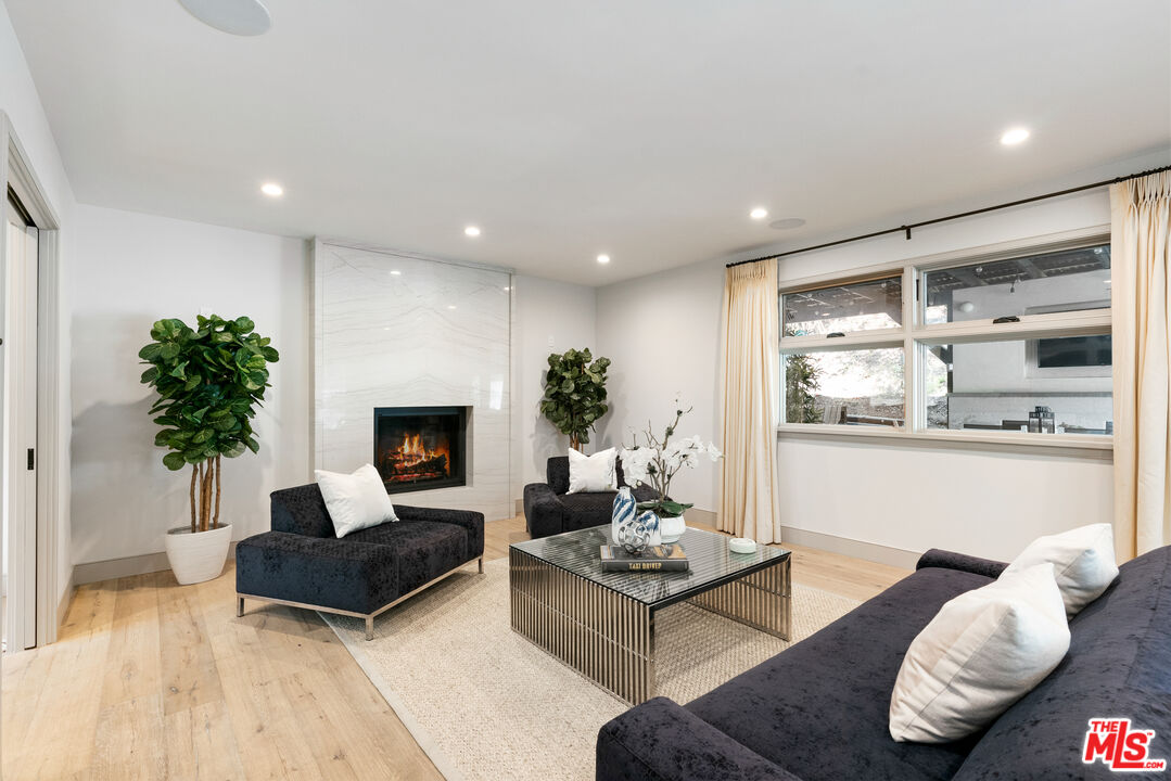 1104 Acanto Place Los Angeles, CA 90049 - Photo 10 of 39 a living room with furniture and a fireplace