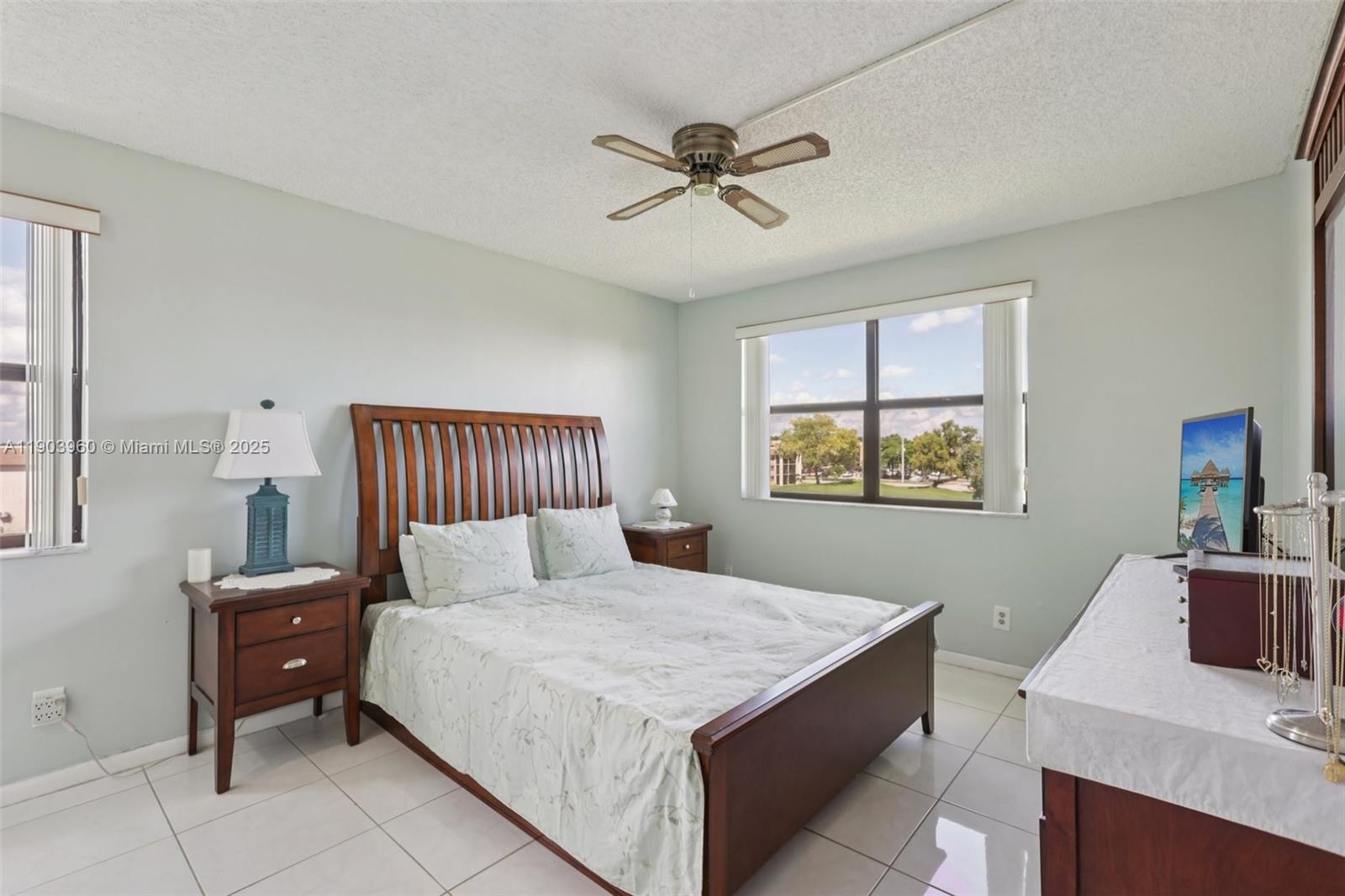 2793 Northwest 104th Avenue, Unit 401 Sunrise, FL 33322 - Photo 12 of 28 a bed room with a bed and a desk