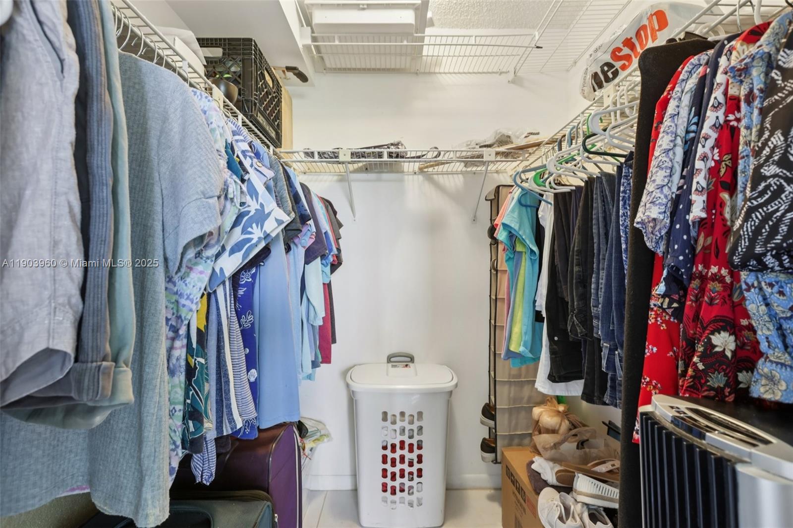 2793 Northwest 104th Avenue, Unit 401 Sunrise, FL 33322 - Photo 14 of 28 a view of walk in closet with clothes and shoes