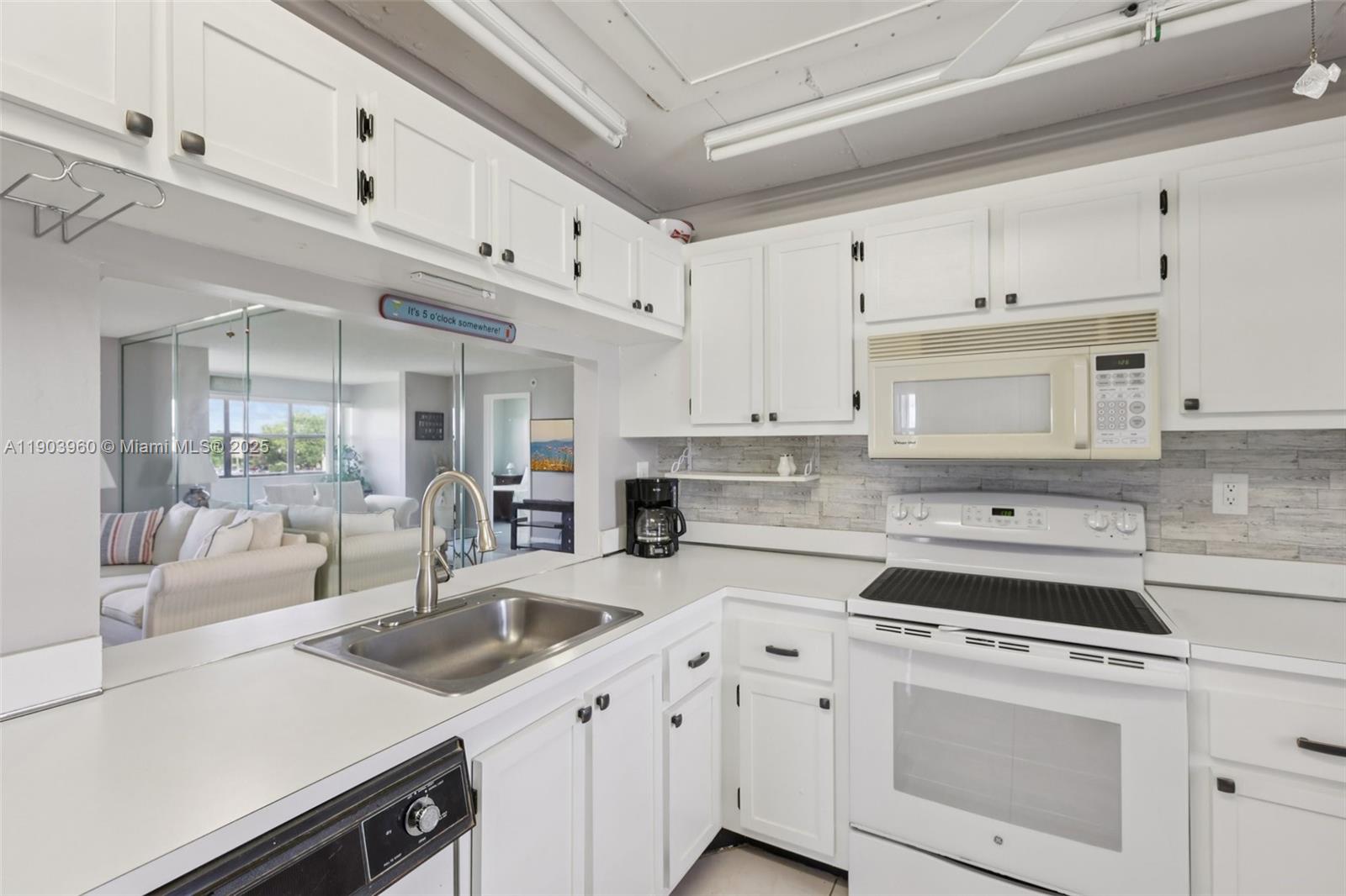 2793 Northwest 104th Avenue, Unit 401 Sunrise, FL 33322 - Photo 6 of 28 a kitchen with cabinets appliances a sink and a counter top space