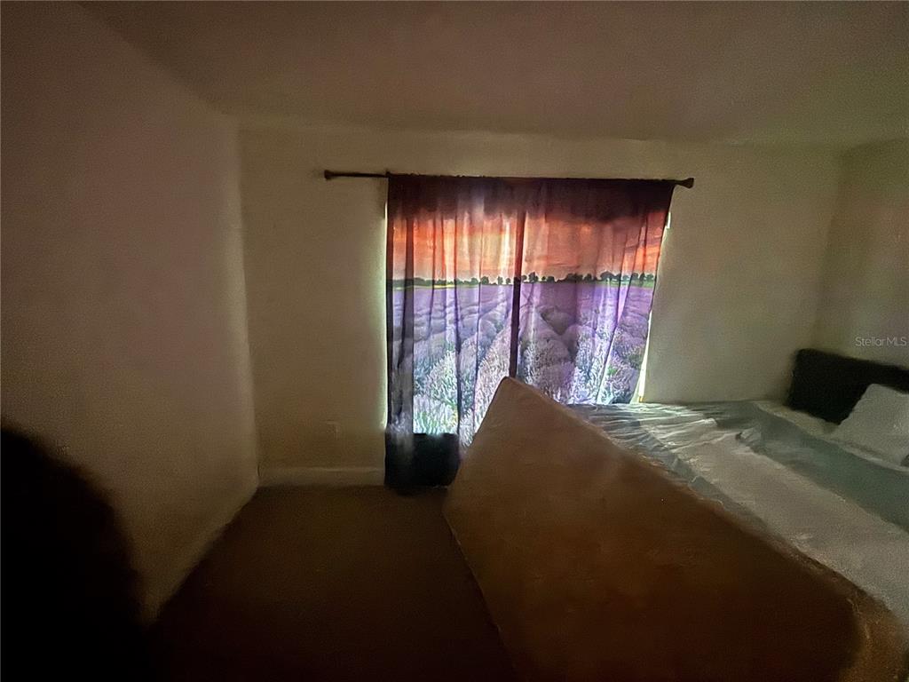 12214 Legacy Bright Street Riverview, FL 33578 - Photo 14 of 16 a bed sitting in a bedroom next to a window