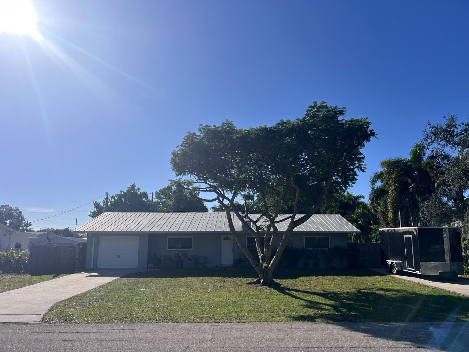 1138 Southwest 33rd Street Palm City, FL 34990 - Photo 2 of 5 a view of a yard in front of a house