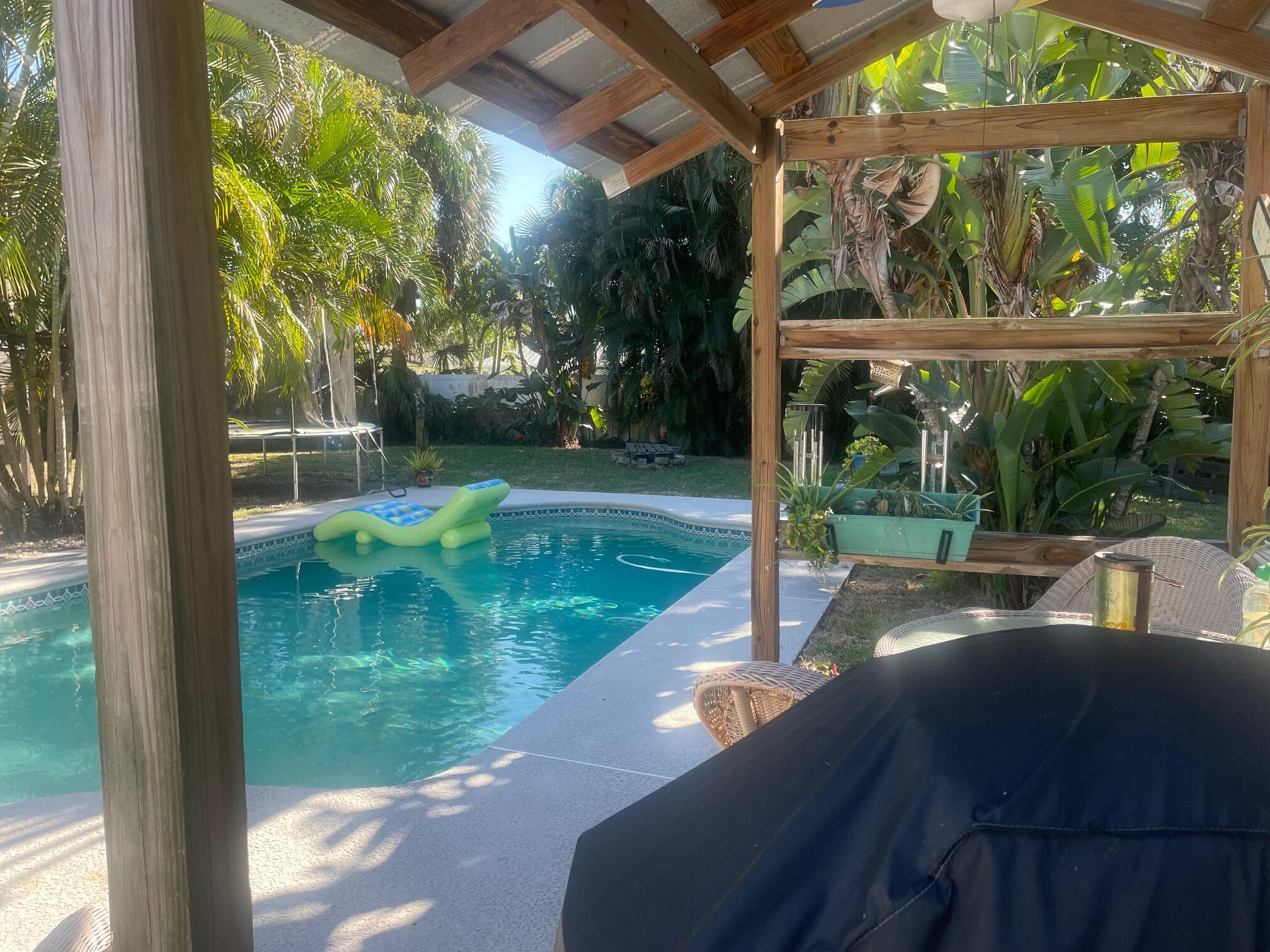 1138 Southwest 33rd Street Palm City, FL 34990 - Photo 5 of 5 a view of a patio with a table and chairs