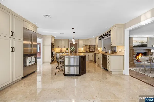 a view of kitchen with furniture and refrigerator