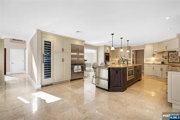 a kitchen with stainless steel appliances a sink and cabinets