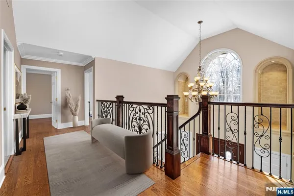 a view of a hallway with couches a dining table and chairs