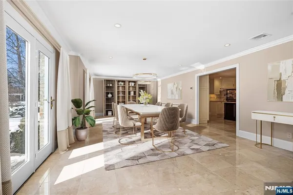 a dining room with a table and chairs