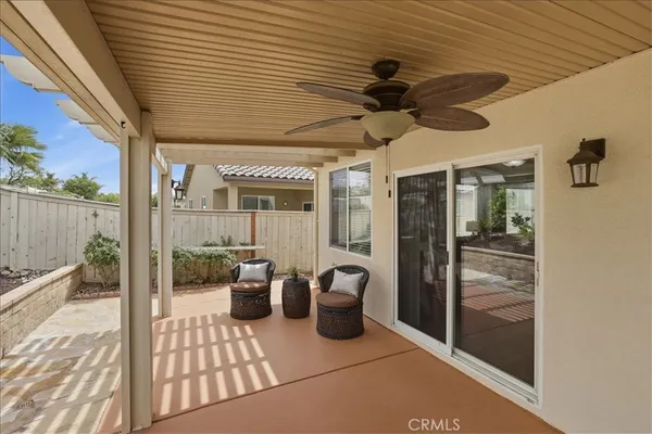a view of a patio with table and chairs