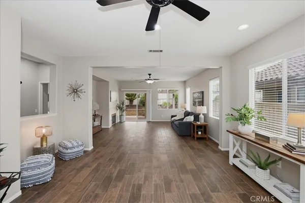 a living room with furniture and wooden floor