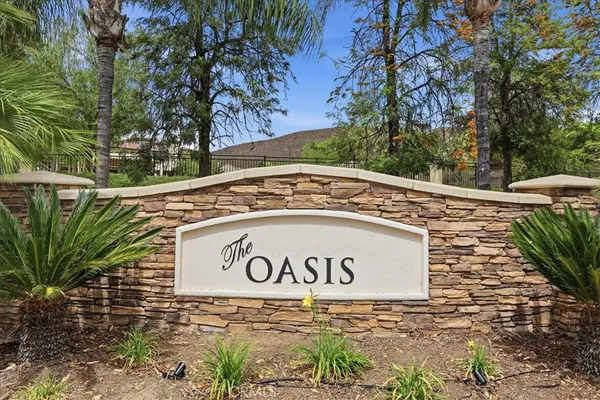 a view of a sign under a tree
