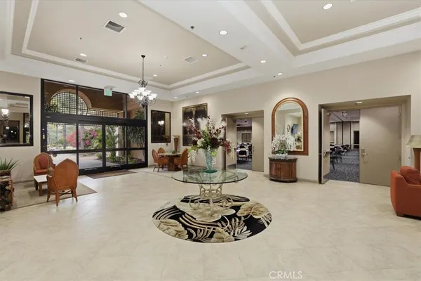 a living room with furniture a large window and flat screen tv