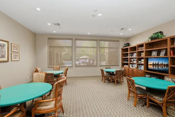 a living room with furniture a bookshelf and a large window