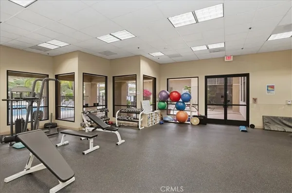 a room with gym equipment and a large window