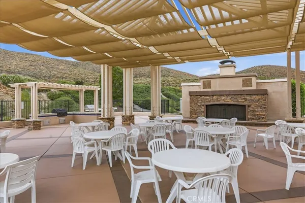 a view of a patio with a table and chairs