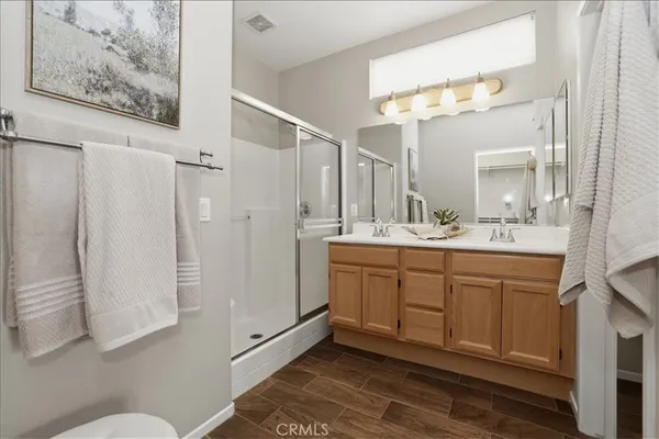 a bathroom with a double vanity sink mirror and toilet