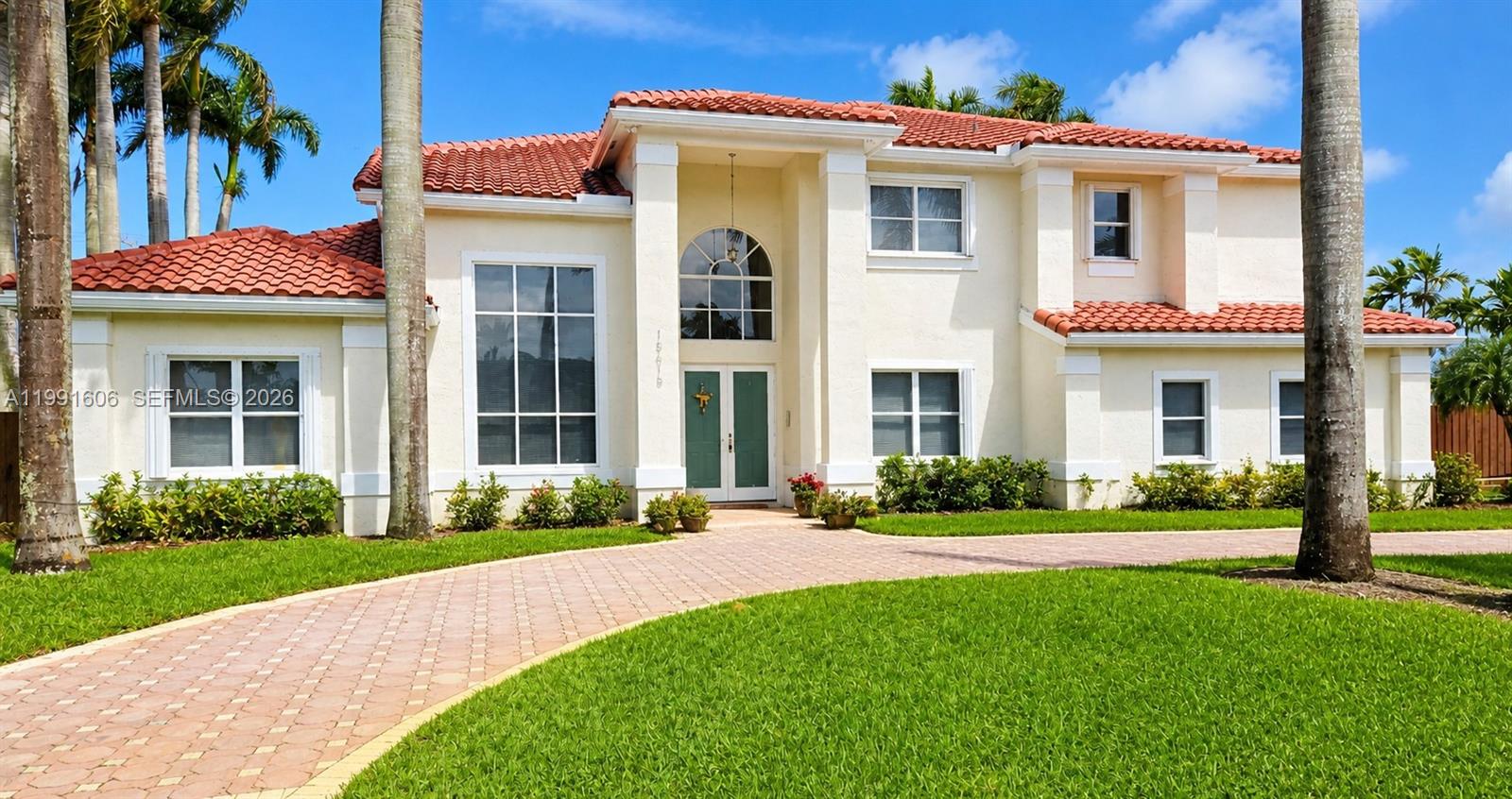 15615 Southwest 42nd Terrace Miami, FL 33185 - Photo 1 of 28 a front view of a house with a yard