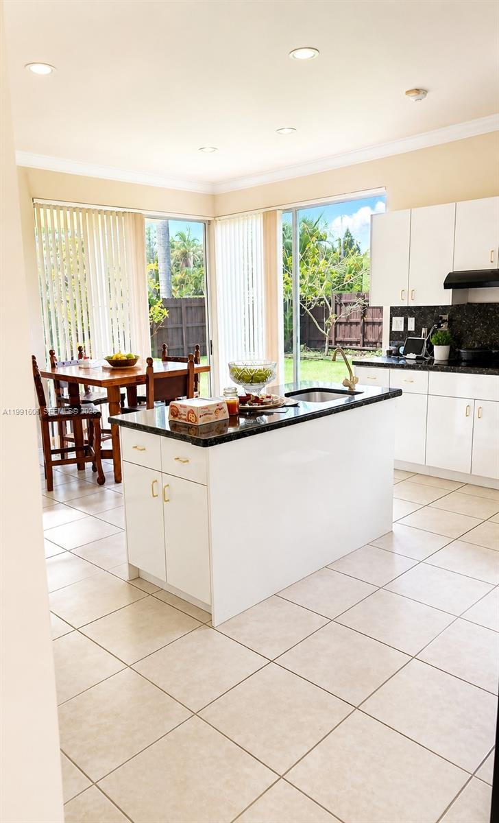 15615 Southwest 42nd Terrace Miami, FL 33185 - Photo 11 of 28 a kitchen with stainless steel appliances granite countertop a stove a sink and a microwave