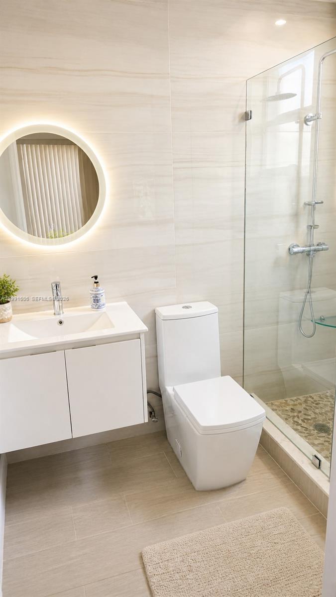 15615 Southwest 42nd Terrace Miami, FL 33185 - Photo 15 of 28 a bathroom with a sink a toilet and shower