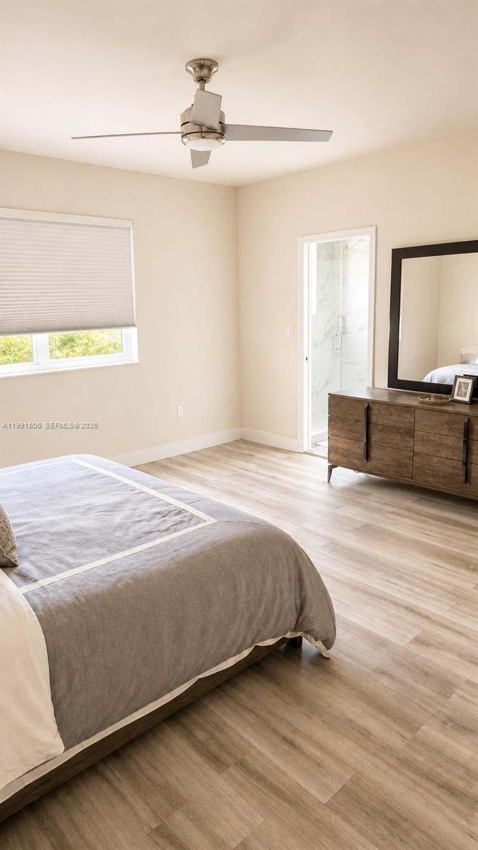 15615 Southwest 42nd Terrace Miami, FL 33185 - Photo 19 of 28 a bedroom with a bed and wooden floor