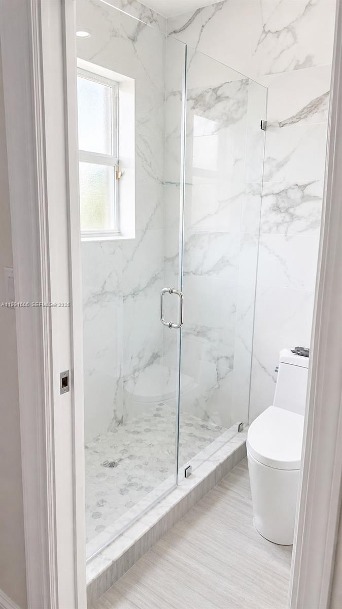 15615 Southwest 42nd Terrace Miami, FL 33185 - Photo 20 of 28 a bathroom with a shower and a toilet