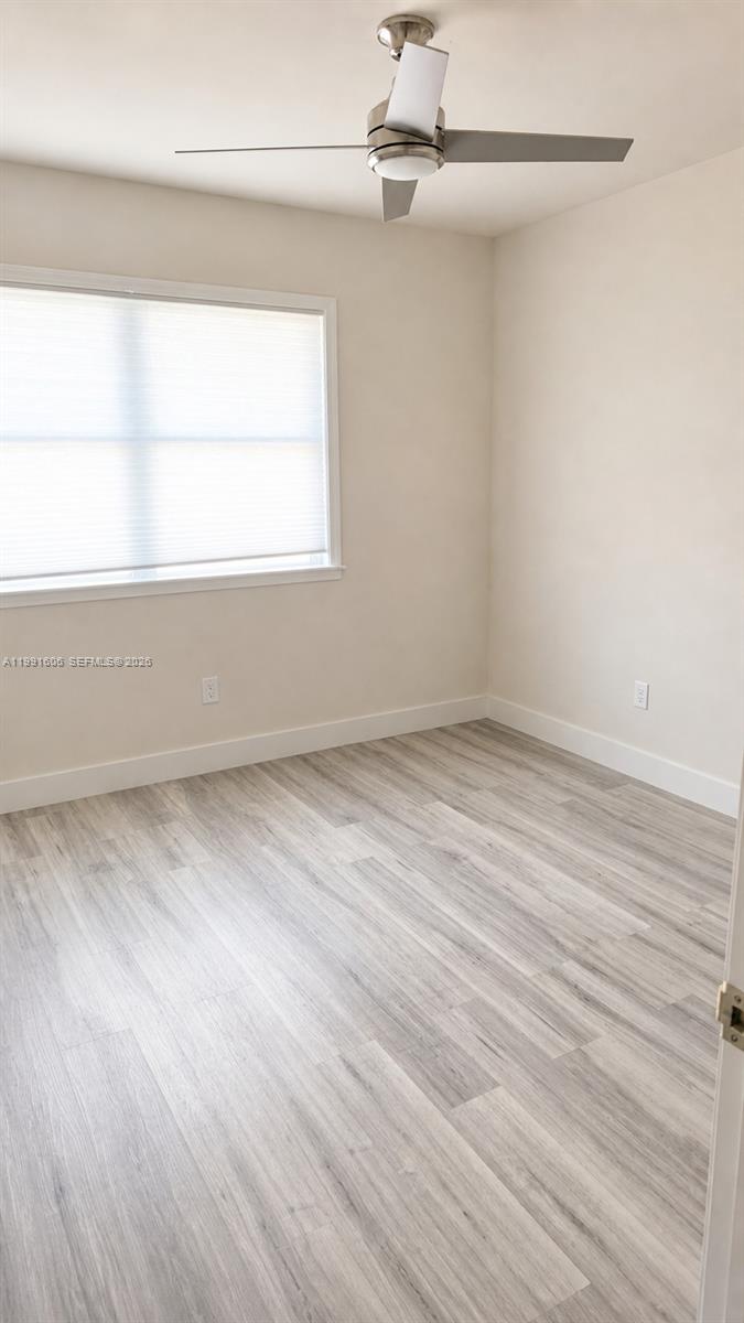 15615 Southwest 42nd Terrace Miami, FL 33185 - Photo 21 of 28 a view of room with window and hardwood floor